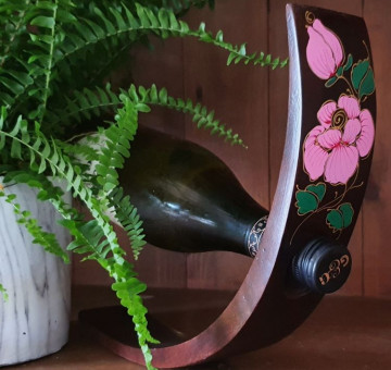 hand carved wooden curved wine bottle holder with a pink rose design
