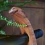 hand carved curved balancing wine bottle holder with a lizard design