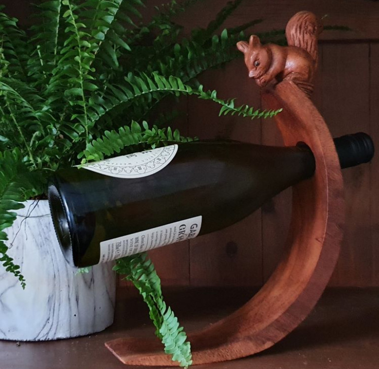 hand carved curved balancing wine bottle holder with a squirrel design