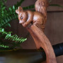 hand carved curved wooden balancing wine bottle holder with a squirrel peering over the top design