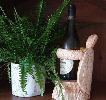 hand carved suar wood wine bottle holder in the shape of a turtle