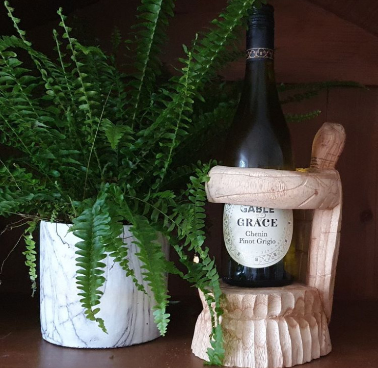 hand carved suar wood wine bottle holder in the shape of a turtle