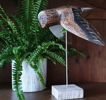 Wooden hand carved and painted flying owl on plinth