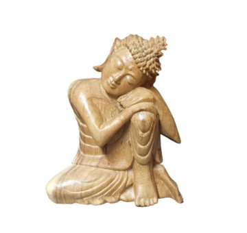 Wooden carved dreaming buddha, a Buddha sitting and resting again a bent up knee, a calming statue