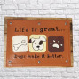 A wooden and tin sign with a brown painted front saying Life is Great....Dogs make it Better