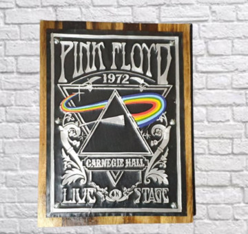 a wooden backboard with a painted tin front of the Pink Floyd logo live on stage at Carnegie Hall