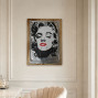 A wooden backboard with a tin embossed and painted front picture of Marilyn Monroe