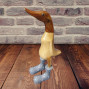 a small wooden hand carved bamboo duck with a grey boot