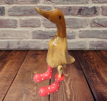 a small hand carved wooden bamboo duck with red boots