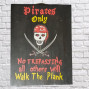 A wooden painted sign with black background, the wording of Pirates Only No Trepassing all other will walk the plank