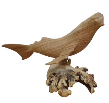 A hand carved whale attached to decorative parasite wood