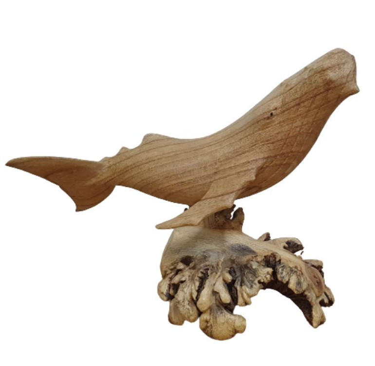 A hand carved whale attached to decorative parasite wood