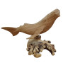 A hand carved whale attached to decorative parasite wood