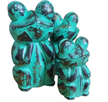 a family of hand carved green frogs