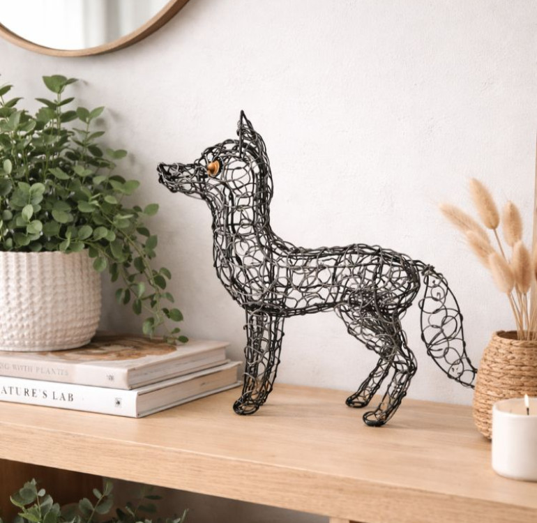 A silver meshed wire fox statue with bushy tail standing proud for your garden