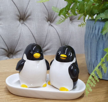 a set of baby penguin novelty salt and pepper ceramic shakers on a base