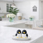 a set of baby penguin novelty salt and pepper ceramic shakers on a base