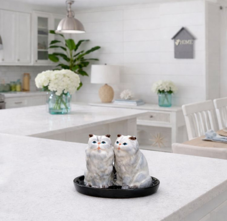 A set of grey fluffy cat salt and pepper shakers made from ceramic on a base