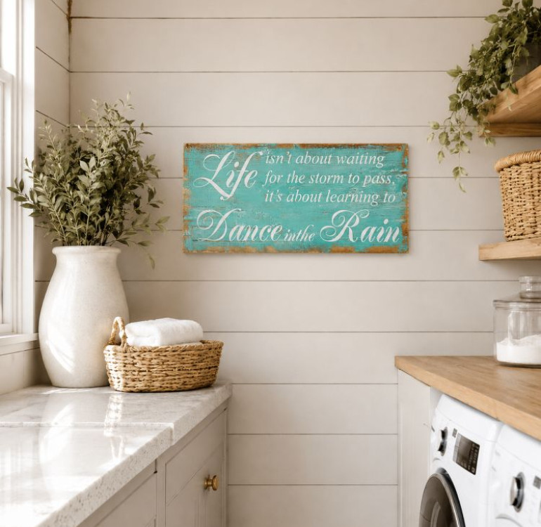 a wooden painted sign with the words Life isn't about waiting for the storm to pass it's about learning to Dance in the rain, coastal wind washed sign with twisted rope hanging