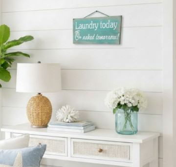 a laundry utility room wooden painted sign saying Laundry today or naked tomorrow