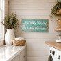 a laundry utility room wooden painted sign saying Laundry today or naked tomorrow