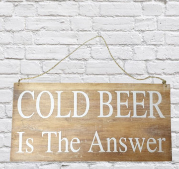 a wooden sign with rustic string hanging loop. Painted in white are the words Cold Beer Is The Answer