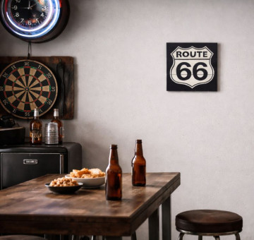 a black and white painted wooden sign "Route 66" logo