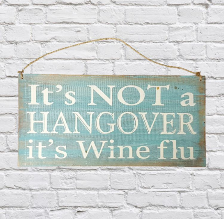 an aqua and white painted wooden sign
