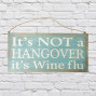 an aqua and white painted wooden sign