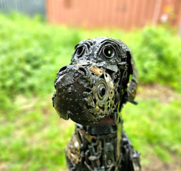 a recycled metal hand crafted dog, great dane in appearance.