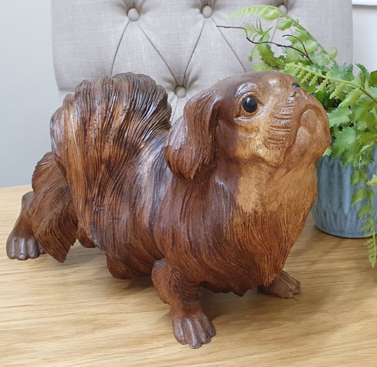 a hand carved wooden Pekingese dog ornament, sculpture, statue