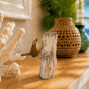 a beautiful hand carved and hand painted wren perching on a piece of natural wood