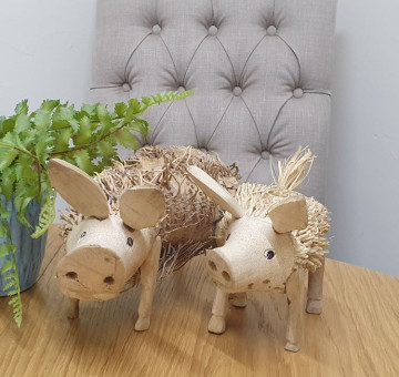 An image of 2 natural bamboo root hand carved pigs, with real character