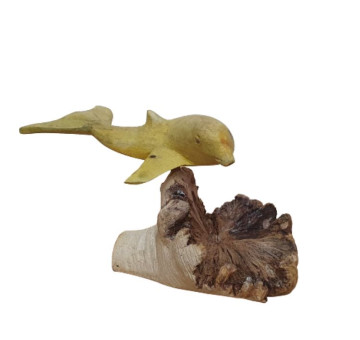 an image of a carved dophin swimming attached to a natural piece of parasite wood