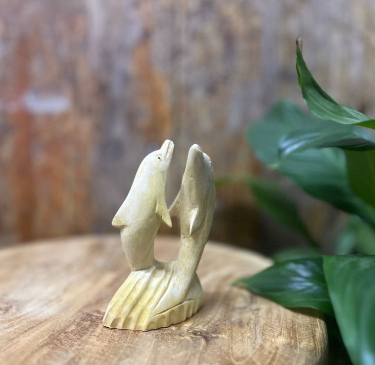 Hand-Carved Wooden Dolphin Statue (11 cm) Bring the beauty of the ocean into your home with this elegant hand-carved wooden sculpture featuring two dolphins twisting gracefully out of the water. Expertly crafted from natural wood, each piece showcases unique grain patterns and smooth, detailed carving that capture the fluid motion of the dolphins. Standing 11 cm high, this compact statue is perfect for a shelf, desk, or mantelpiece, adding a touch of coastal charm and natural artistry to any space. Features: Height: 11 cm (approx. 4.3 inches) Material: Hand-carved natural wood Design: Two dolphins leaping and twisting from the waves Finish: Smooth polished surface with visible wood grain Perfect for: Ocean lovers, beach décor, and nature-inspired interiors Celebrate craftsmanship and marine beauty with this timeless wooden dolphin sculpture — a small yet captivating accent that brings serenity and movement to your décor