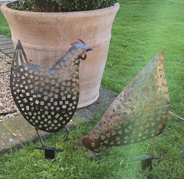 An image of a pair of hand crafted metal chickens for your garden border.