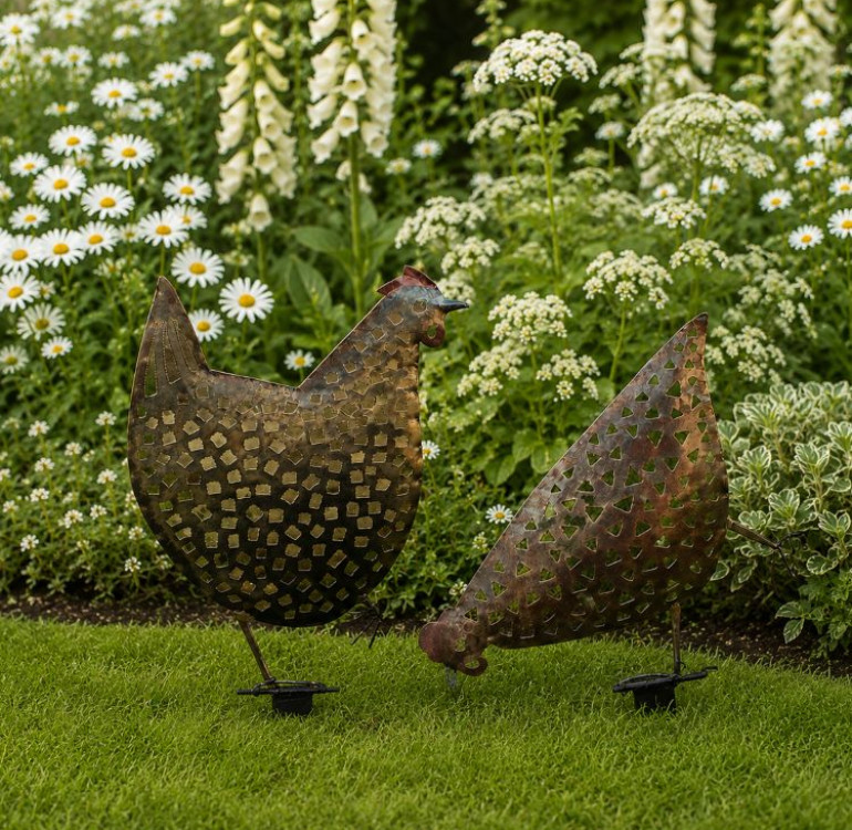 An image of a pair of hand crafted metal chickens for your garden border.