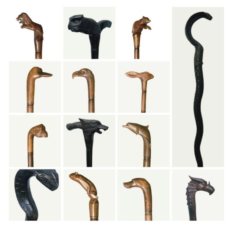 a selection of handmade carved wooden decorative walking sticks