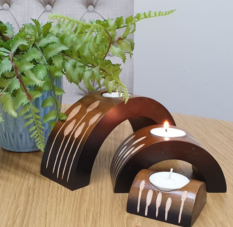 an example of a set of 3 hand carved T-light holders with a wood carving design decoration. The candle holders themselves in a arch shape