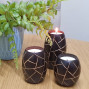 an example of a set of 3 barrel shape wooden candle holders hand carved with an abstract design, designs differ from set to set