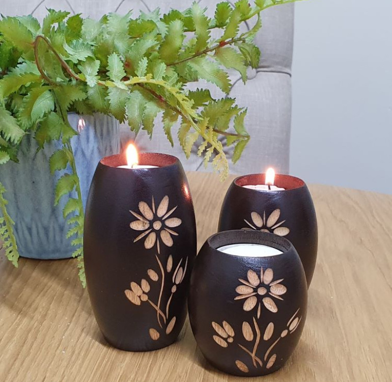 an example of a set of 3 hand carved barrel shape candle holders with a flower design, please note flower designs differ from set to set