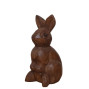 a hand carved rabbit sitting surveying everything around him ornament