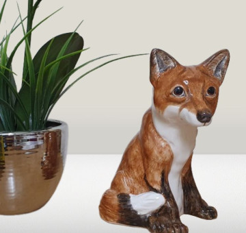 A ceramic hand painted money box/ piggy bank in the shape and design of a gorgeous fox