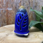 a handmade ceramic incense holder burner in a royal blue colour, cone shaped with an ochre finish top.