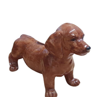 A ceramic hand painted money box/ piggy bank in the shape and design of a brown dachshund