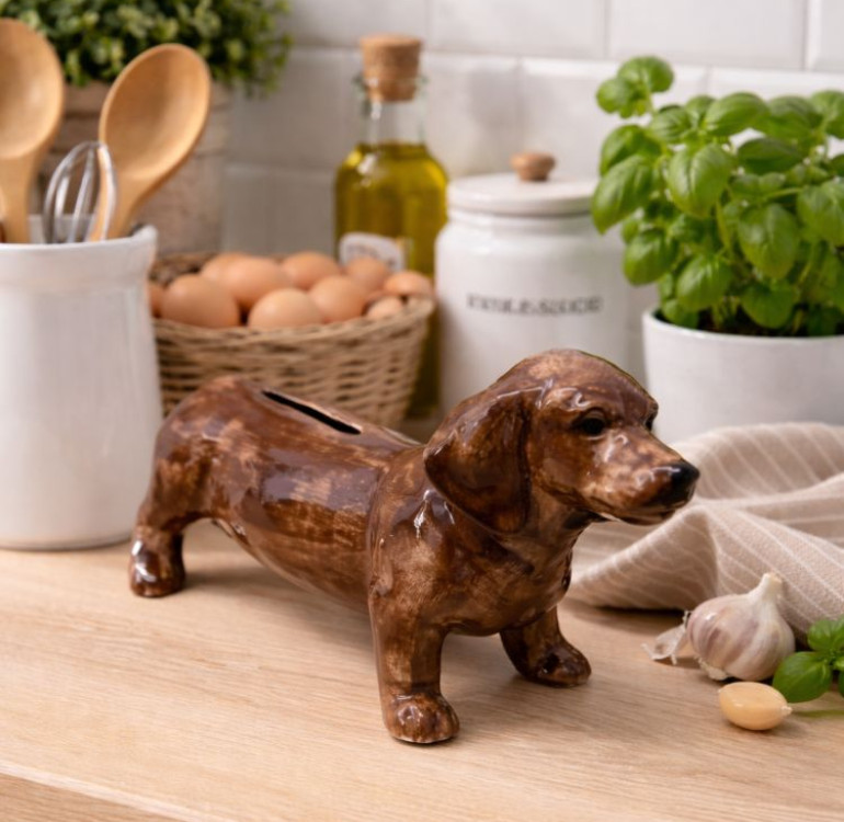 A ceramic hand painted money box/ piggy bank in the shape and design of a brown dachshund