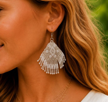 a pair of fan shaped handmade white beaded earrings in an ibiza boho style