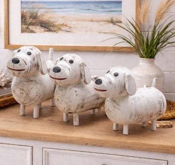 a set of 3 white dog ornaments, wooden and hand painted with a chalky white paint