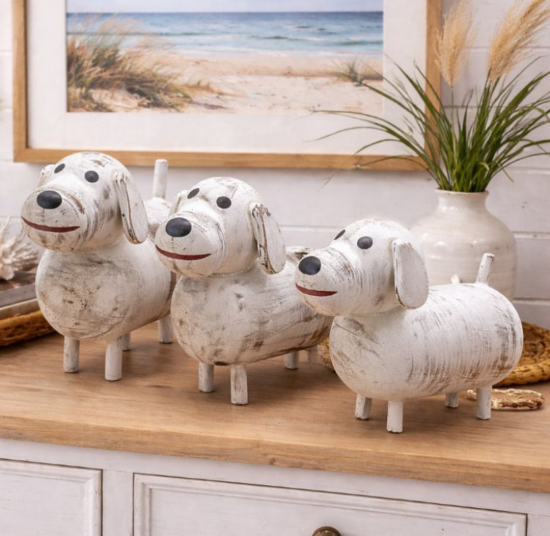 a set of 3 white dog ornaments, wooden and hand painted with a chalky white paint