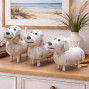 a set of 3 white dog ornaments, wooden and hand painted with a chalky white paint